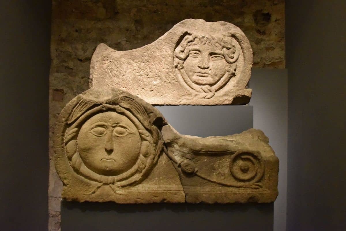 Acroteria of Montjuïc sandstone, 1st century A.D. Decorative elements representing Medusa's head that formed part of the crown of a funerary monument (MUHBA Plaça del Rei).