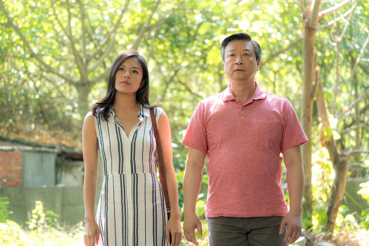 a woman and man stand next to each other