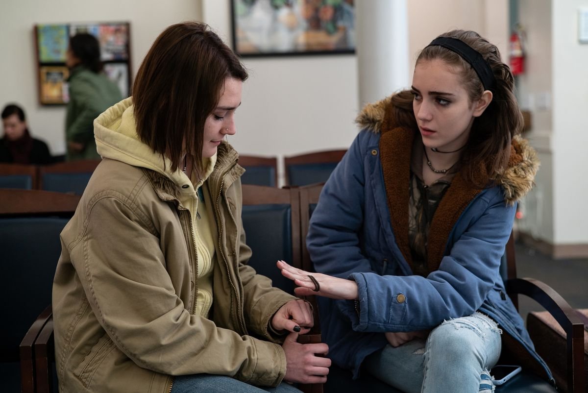 two young women sit together