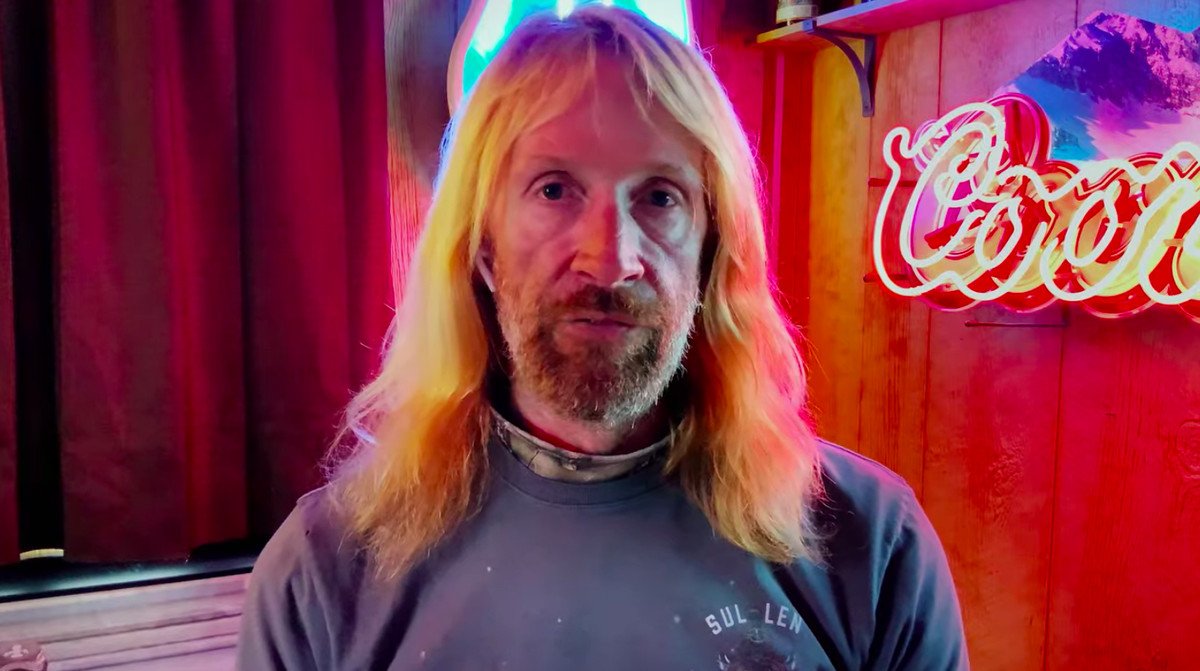 Erik Cowie backlit by a Coors sign