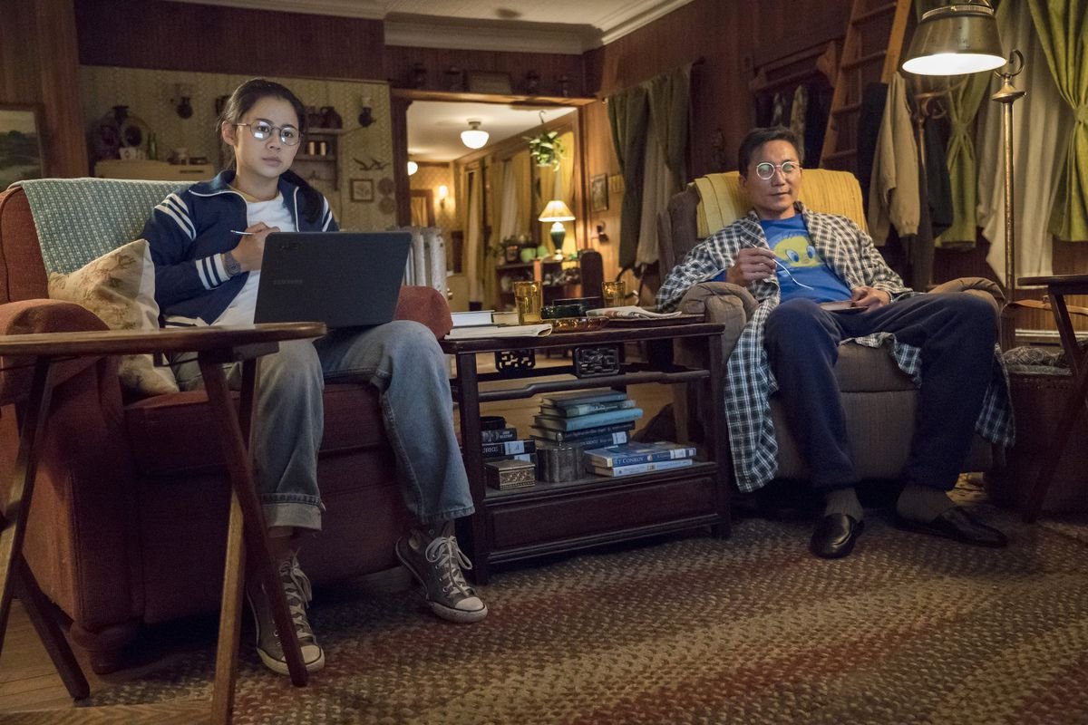 two people watch tv from armchairs