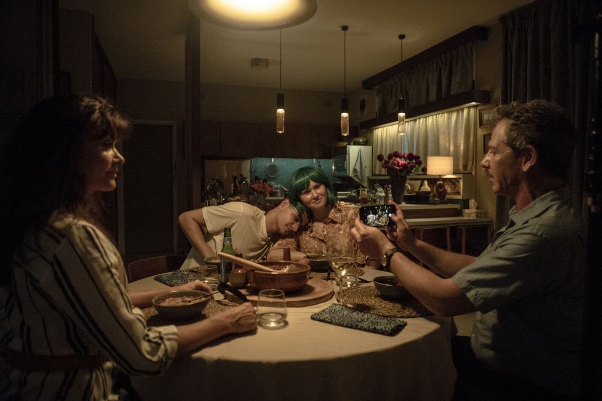 a family sit around a table