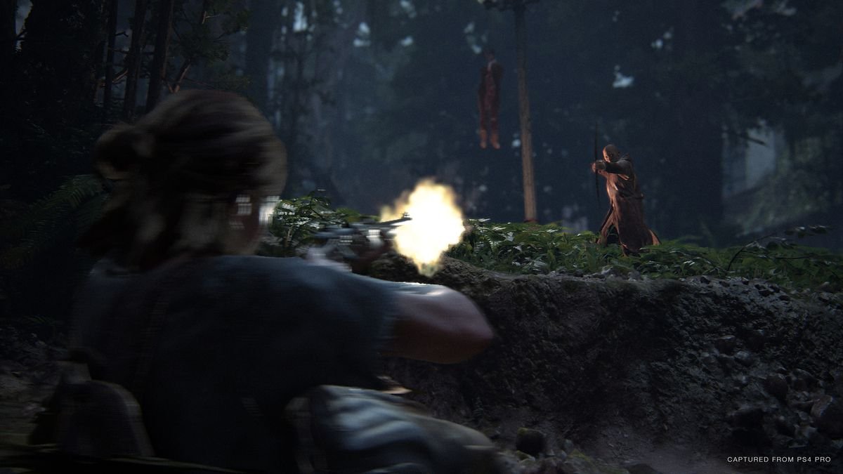 Ellie fires a gun at a hazy enemy in The Last of Us Part 2, with a corpse hanging from a tree behind him