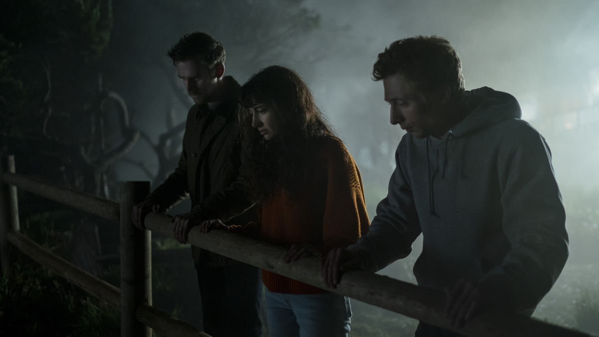 Dan Stevens, Sheila Vand, and Jeremy Allen White look over a fence in a misty scene in Dave Franco’s The Rental.