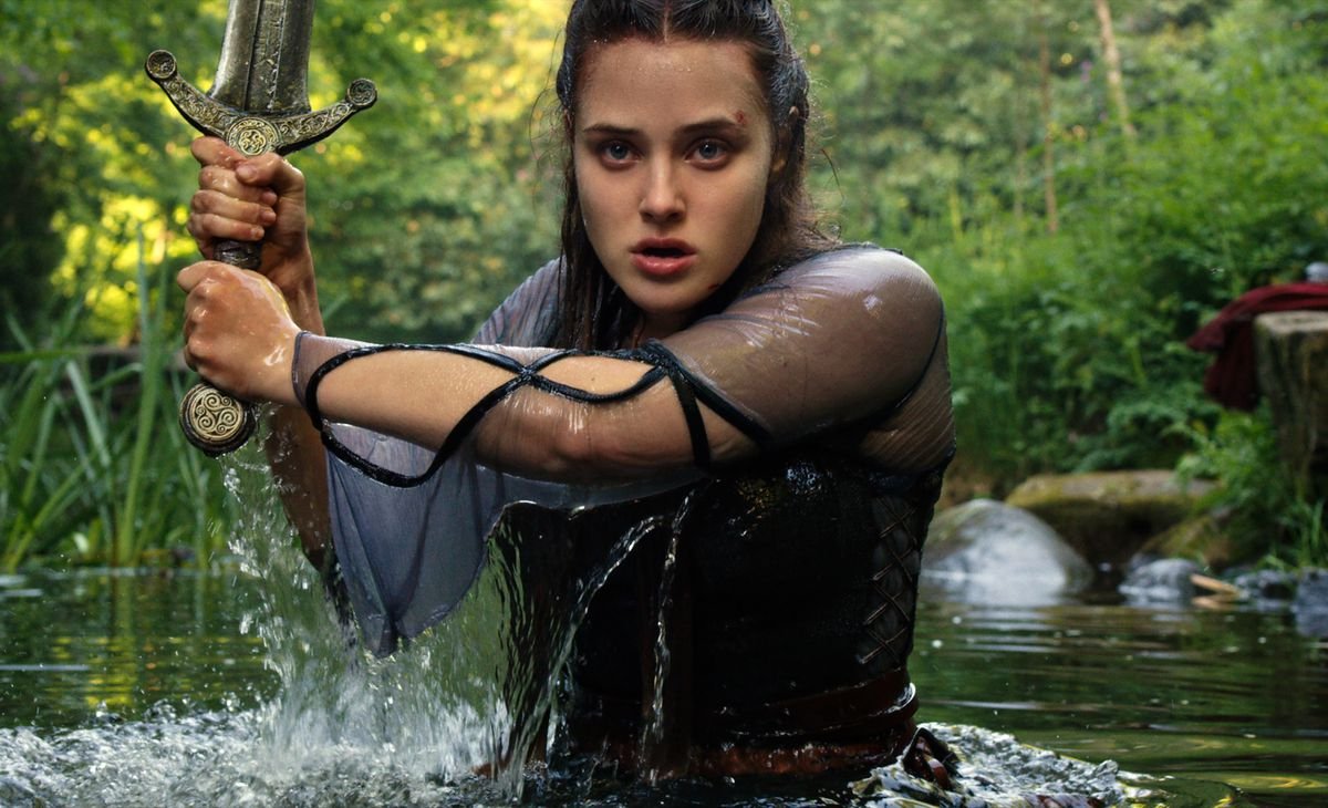 Katherine Langford emerges from the lake with a sword in Cursed