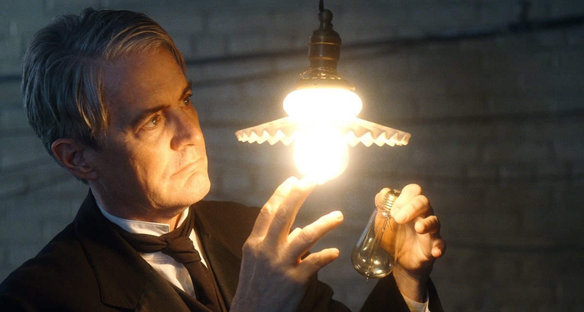 a man inspects a lightbulb