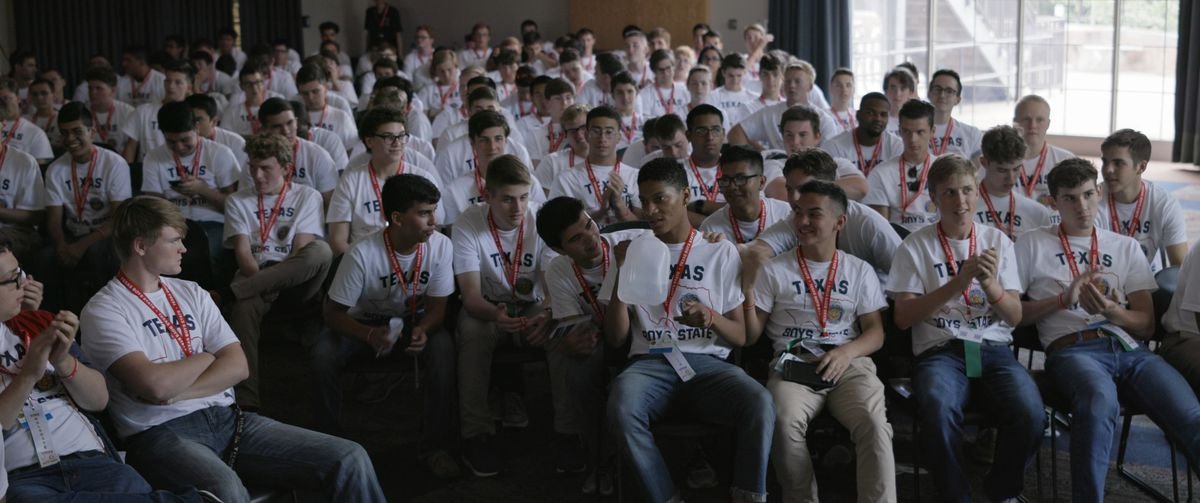 A room full of 16-year-old boys wearing identical T-shirts and lanyards in Boys State.