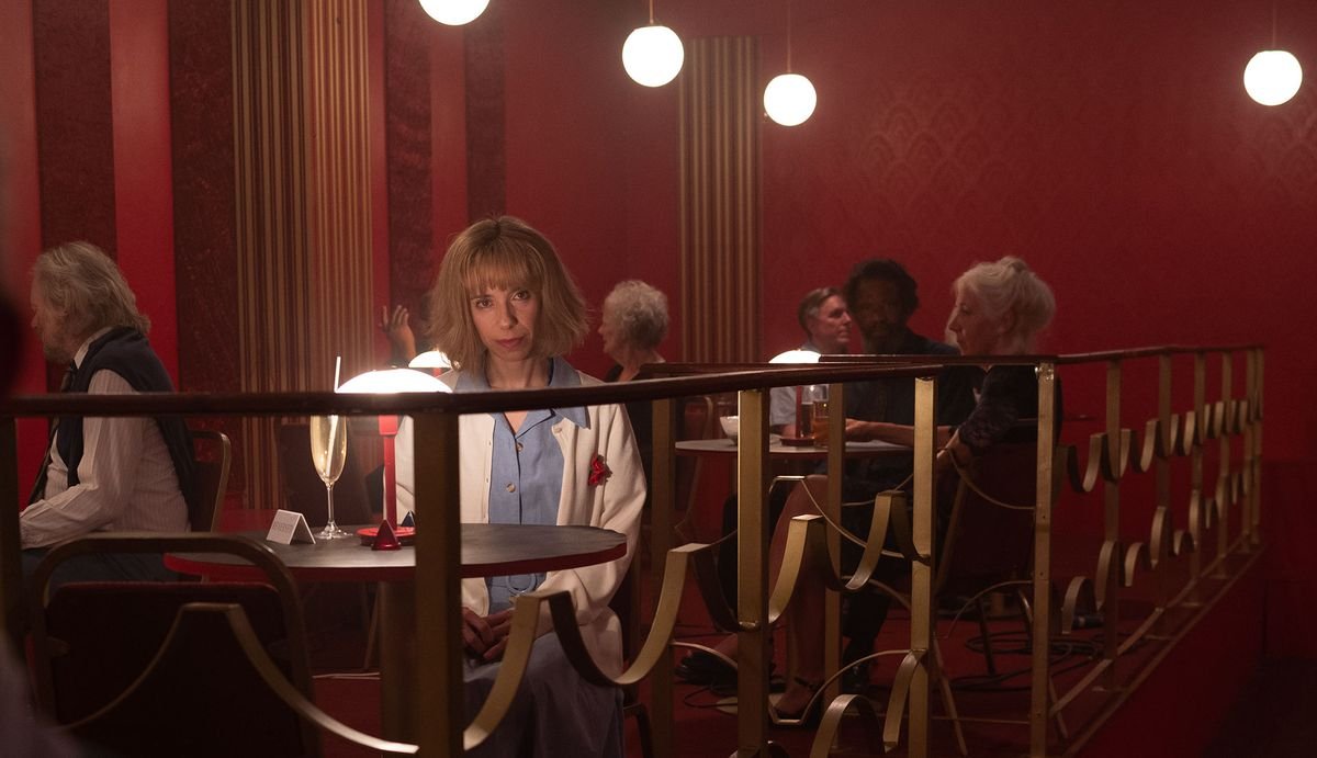 a woman sits alone at a table