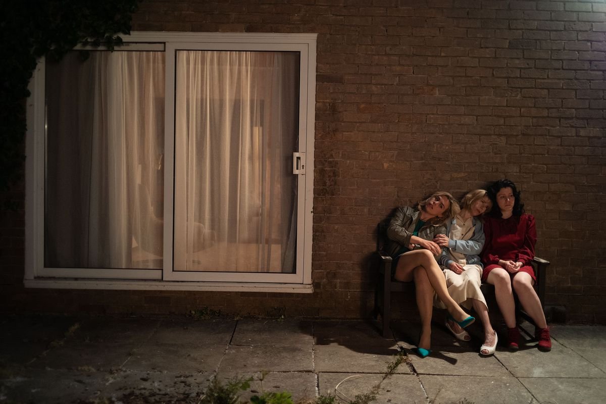 three women sit together