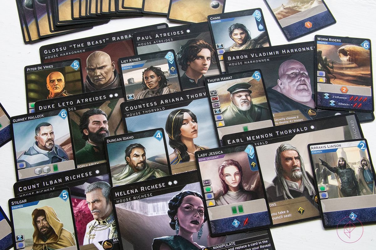 Large player cards, which serve as sideboard during play, interleaved with characters from the other decks of cards that come with Dune: Imperium.