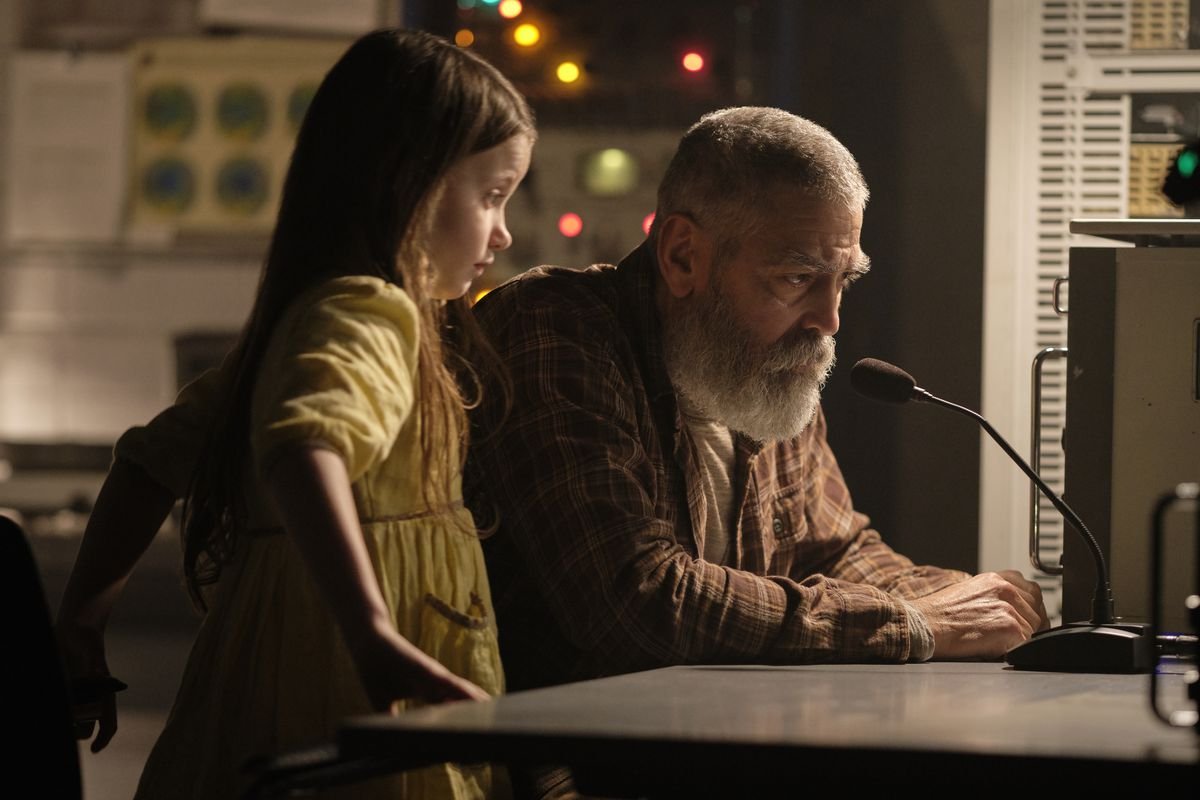 A bearded George Clooney and a little girl sit at a microphone hoping to contact a space station in The Midnight Sky
