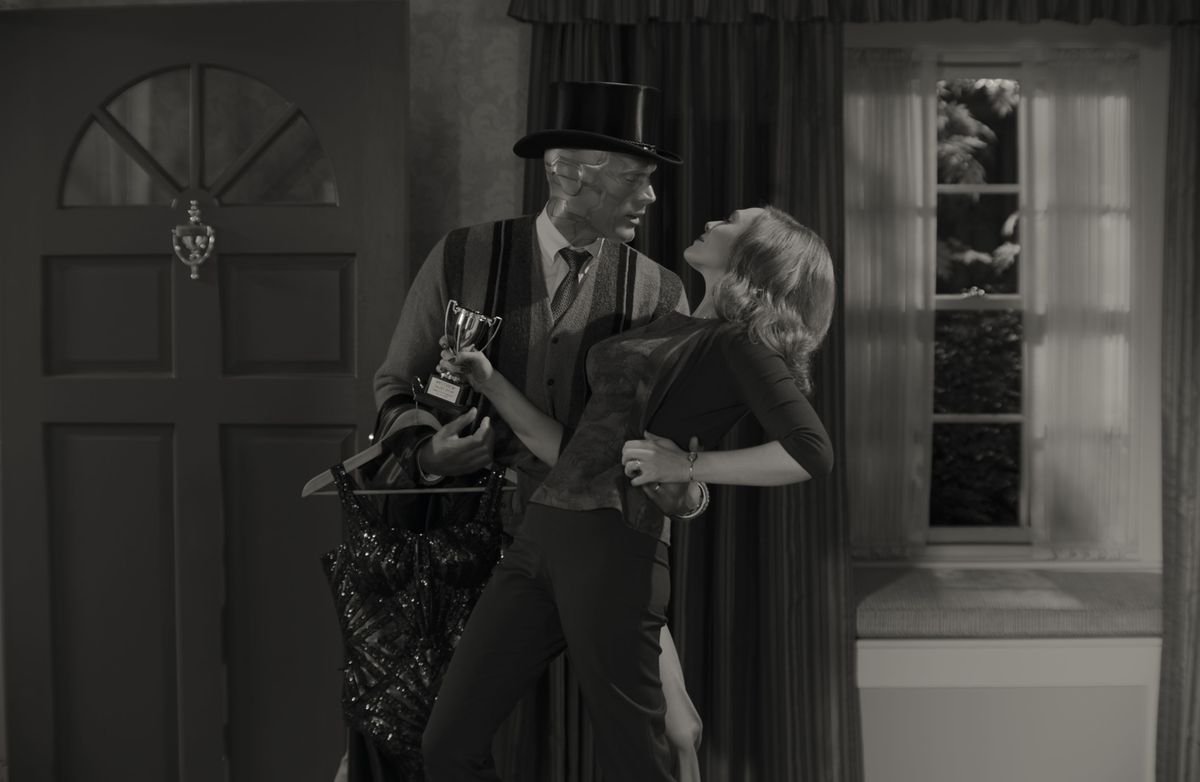 Vision wears a magician’s hat as he dips Wanda at the front door of their house in wandavision