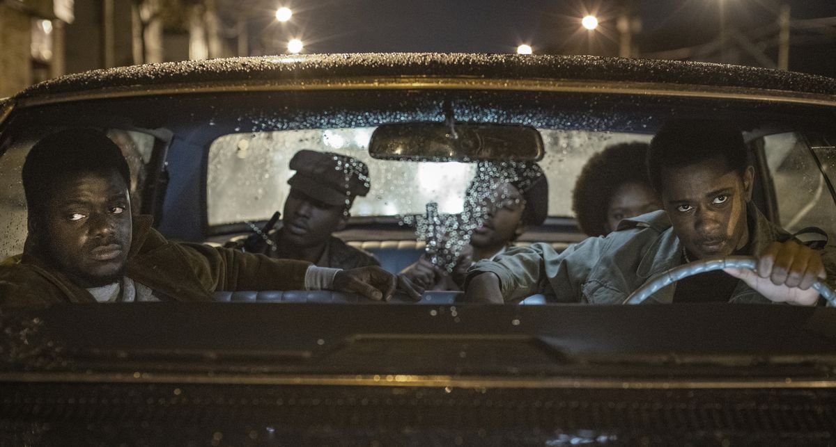 Lakeith Stanfield, Daniel Kaluuya, and a group of Black Panthers in a car at night in Judas and the Black Messiah