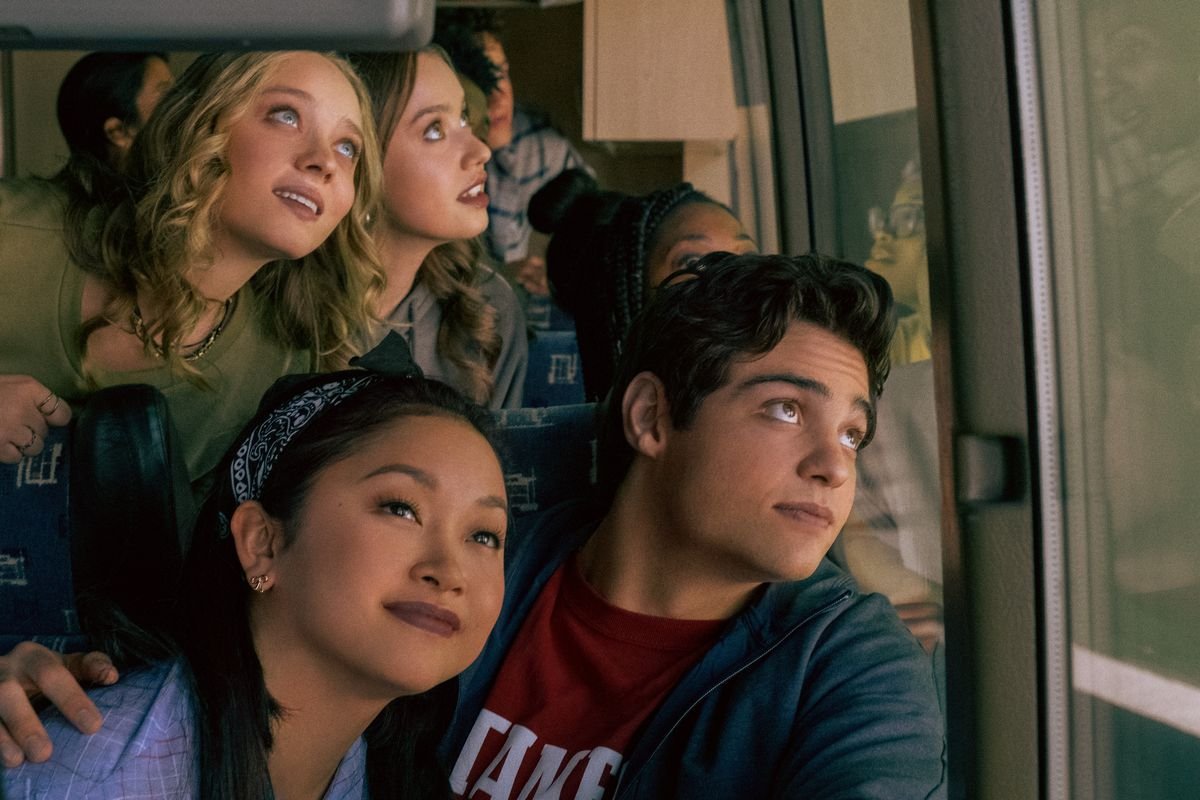 lara jean and peter on a bus, looking out a window