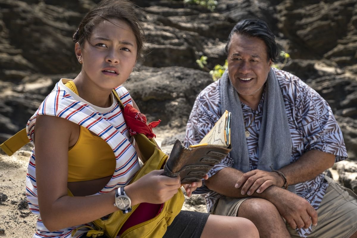 pili and her grandfather looking over the journal