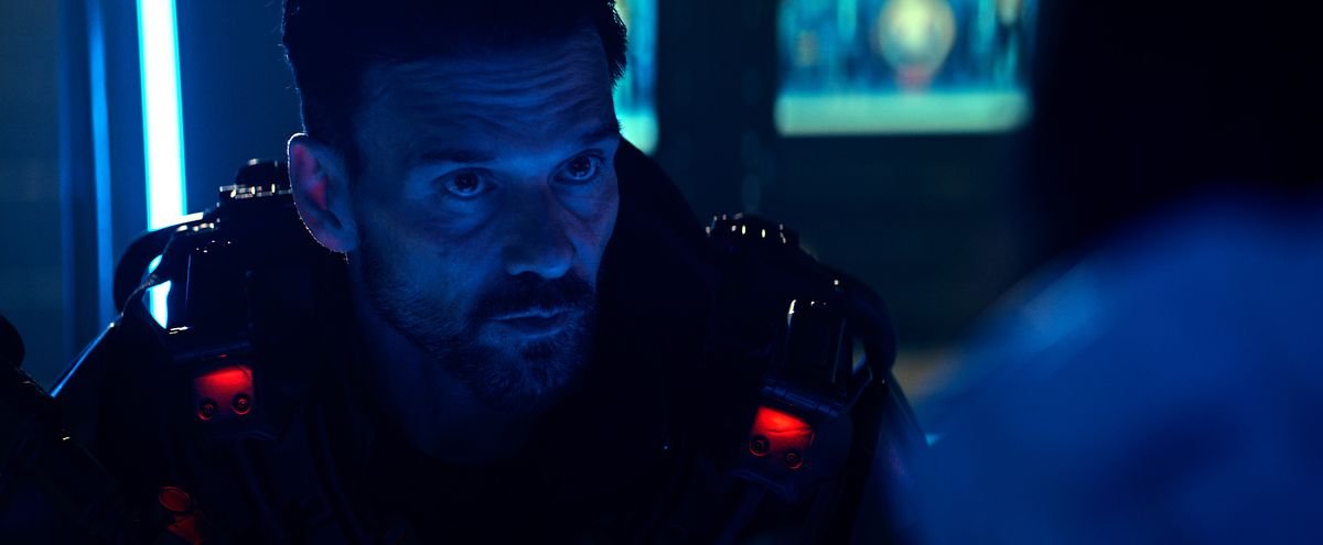 Frank Grillo, glowering in intense blue light in Cosmic Sin