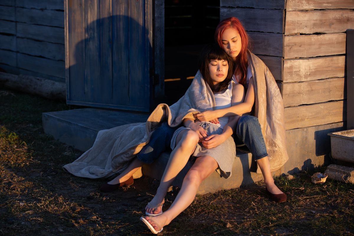 Kiko Mizuhara and Honami Satô cuddle in front of a cabin in Ride or Die
