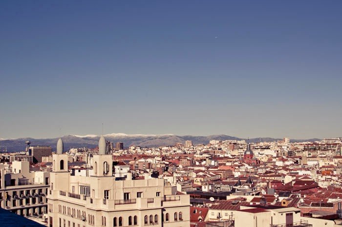 View of the Mountains from the rooftop of a building on a clear sunny day during a weekend in Madrid