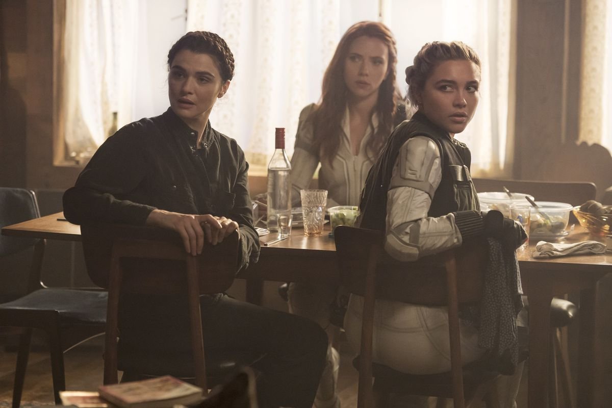 Natasha Romanoff with her surrogate mother, Melina, and sister, Yelena, at the dinner table in Marvel Studios’ Black Widow.