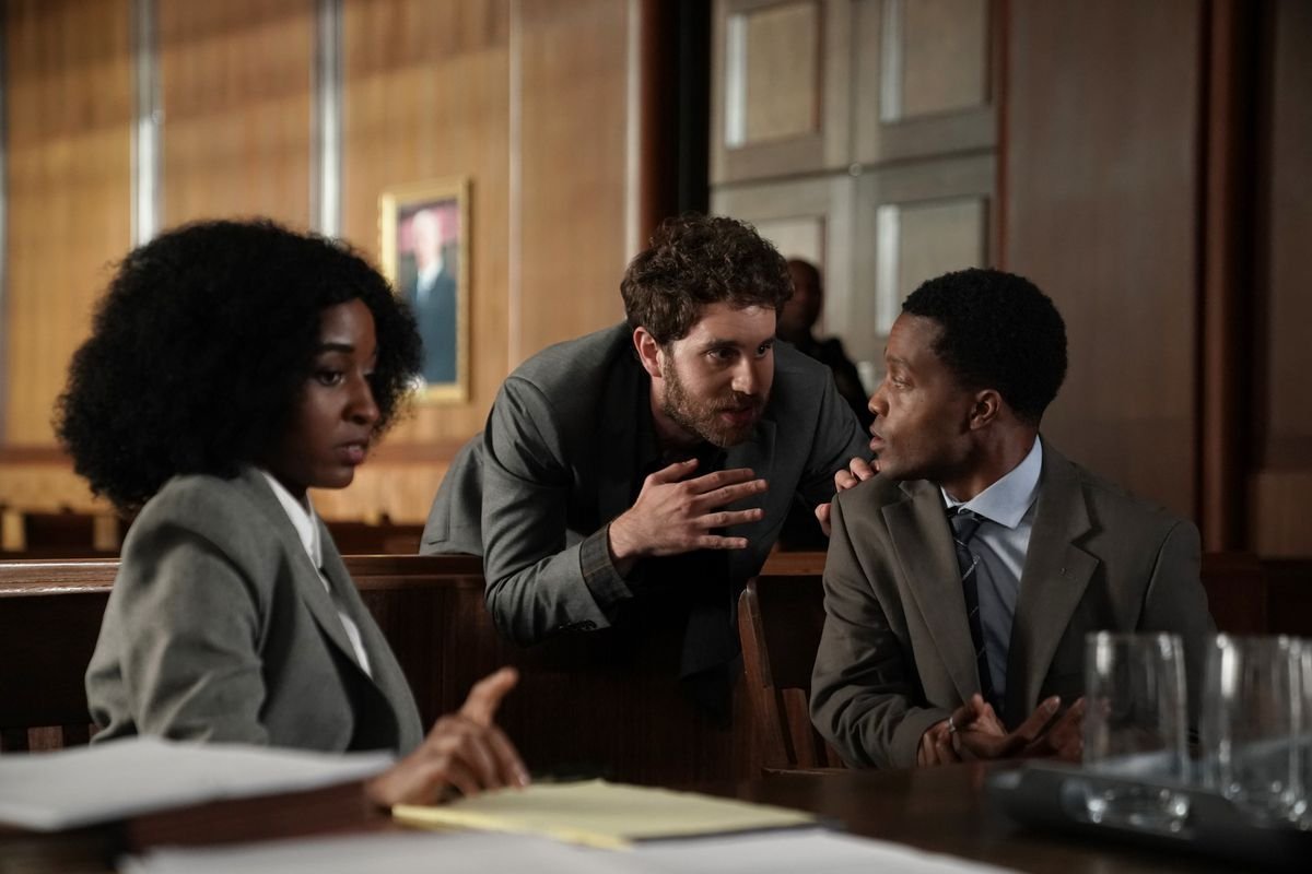 Ayo Edebiri, Ben Platt, and Jermaine Fowler huddle in a courtroom in episode 1 of FX on Hulu’s The Premise.