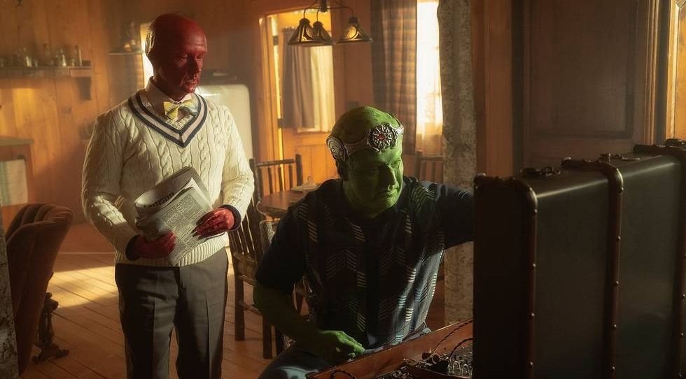 A red-skinned alien and a green-skinned alien fiddle with a suitcase full of outdated-looking technology in season 3 of Doom Patrol