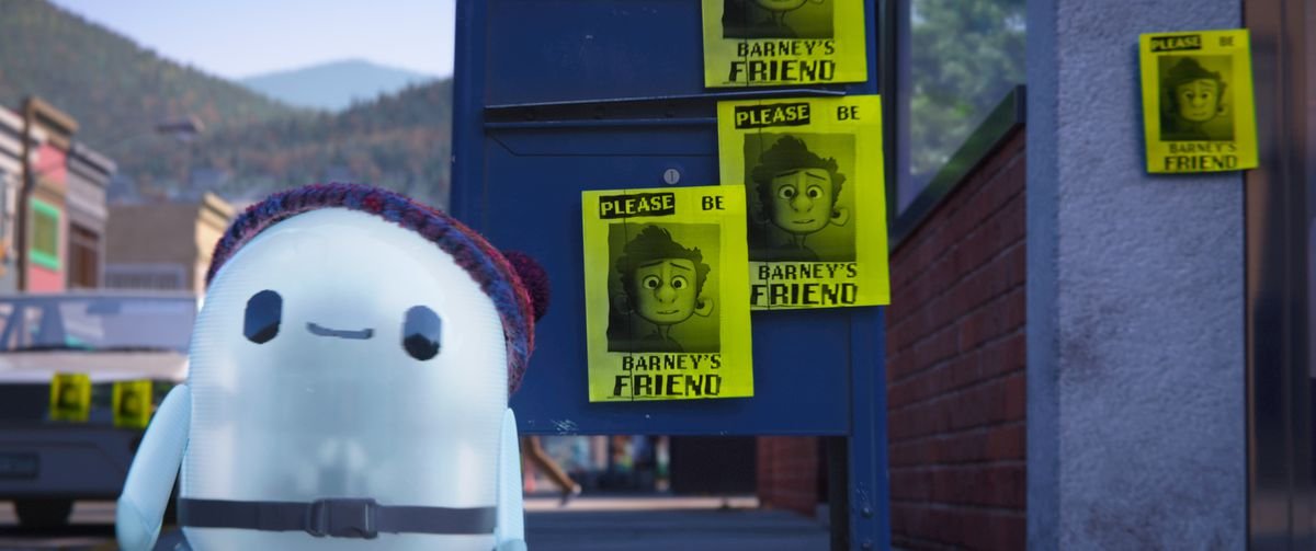 ron standing in front of a bunch of flyers that say “Please Be Barney’s Friend!”