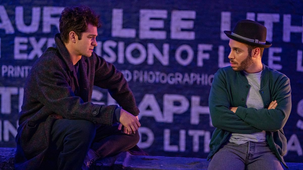 Andrew Garfield and Robin de Jesus sit together in Netflix’s Jonathan Larson musical Tick, Tick… Boom!