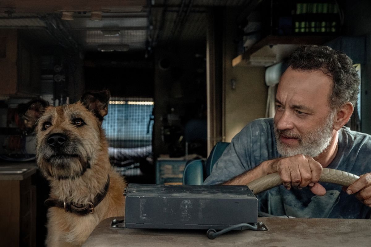 Tom Hanks at the wheel, his loyal dog by his side, in Finch