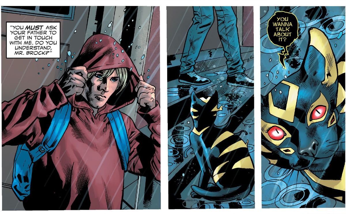 Dylan Brock walks out of a building and into rain, pulling his hoodie up. A black cat with neon yellow markings and four red eyes (the symbiote Sleeper) says “You wanna talk about it?” in Venom #1 (2021). 