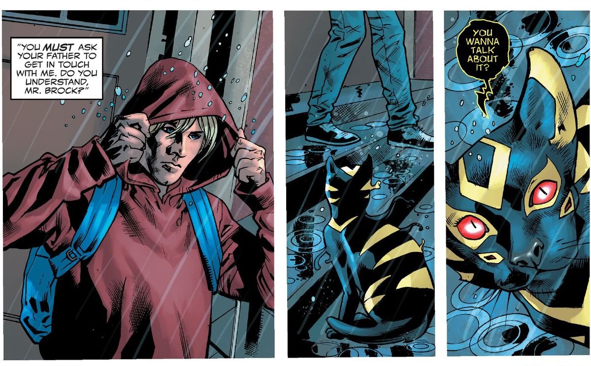 Dylan Brock walks out of a building and into rain, pulling his hoodie up. A black cat with neon yellow markings and four red eyes (the symbiote Sleeper) says “You wanna talk about it?” in Venom #1 (2021).