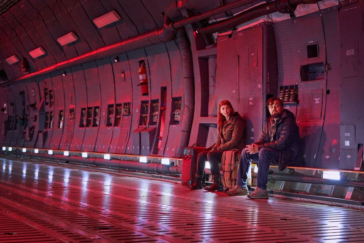 Jennifer Lawrence and Leonardo DiCaprio as Kate Dibiasky and Randall Mindy sit in an empty cargo plane in Netflix’s Don’t Look Up