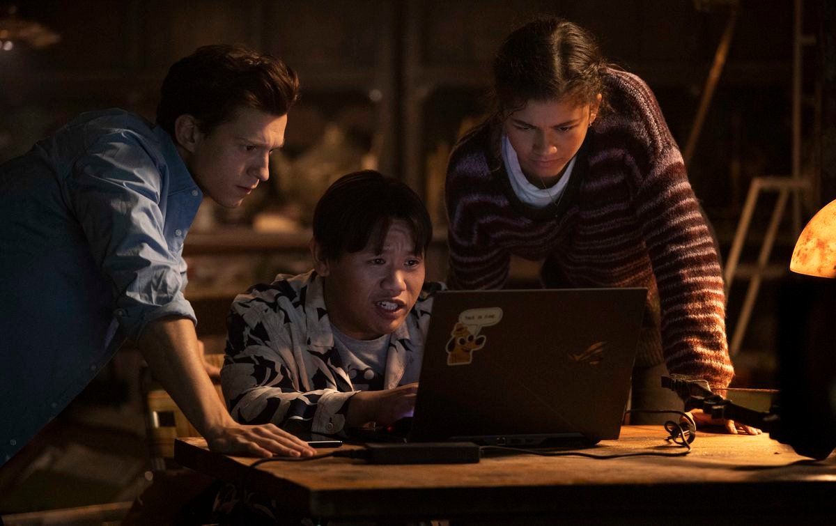 Peter Parker, Ned Leeds, and MJ gather around a laptop in Spider-Man: No Way Home.