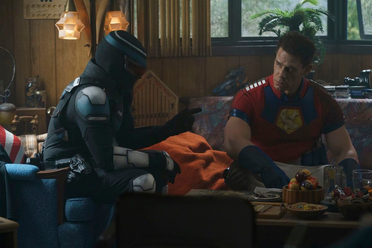 Vigilante and Peacemaker sitting in a still from Peacemaker