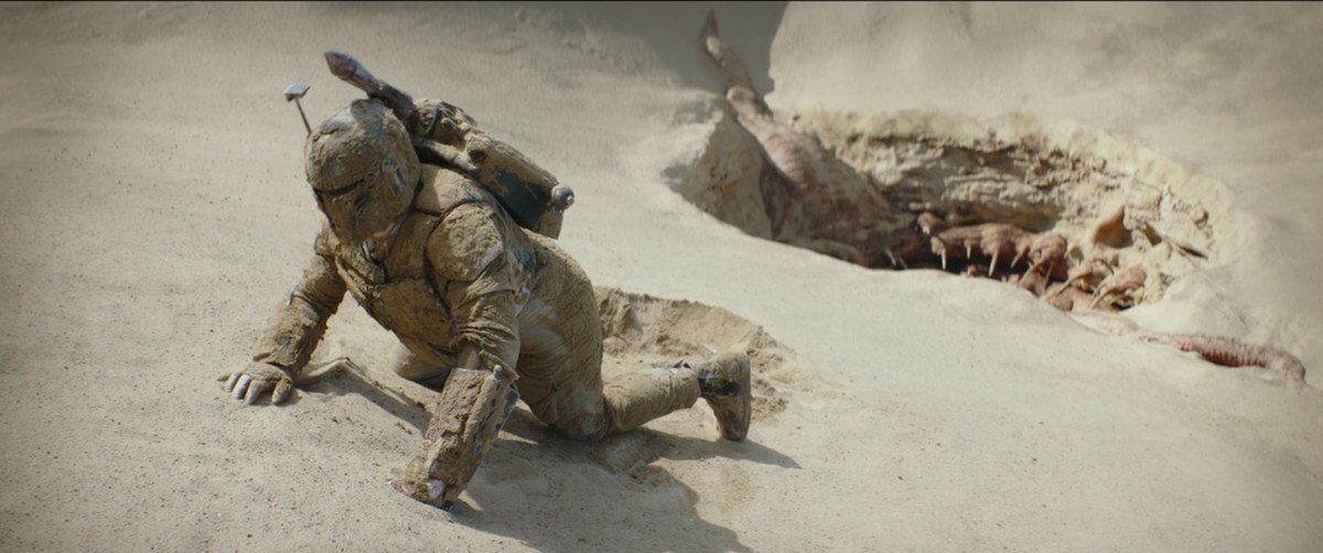 Boba Fett crawling through the sand away from the Sarlacc pit