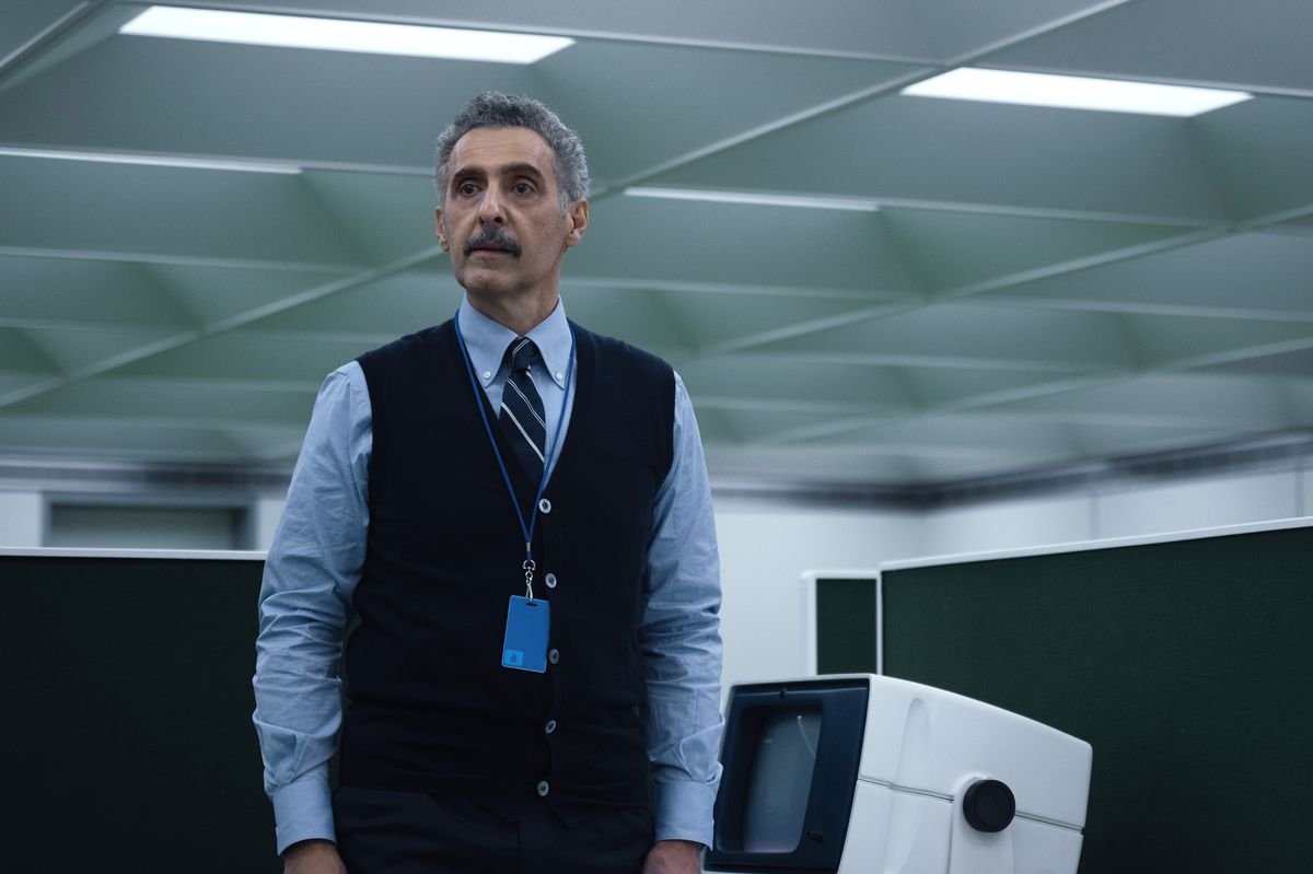 John Turturro standing in an office in Severance