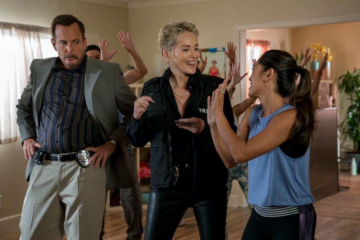 Sharon Stone interviewing a suspect in the middle of a zumba class while Will Arnett looks on