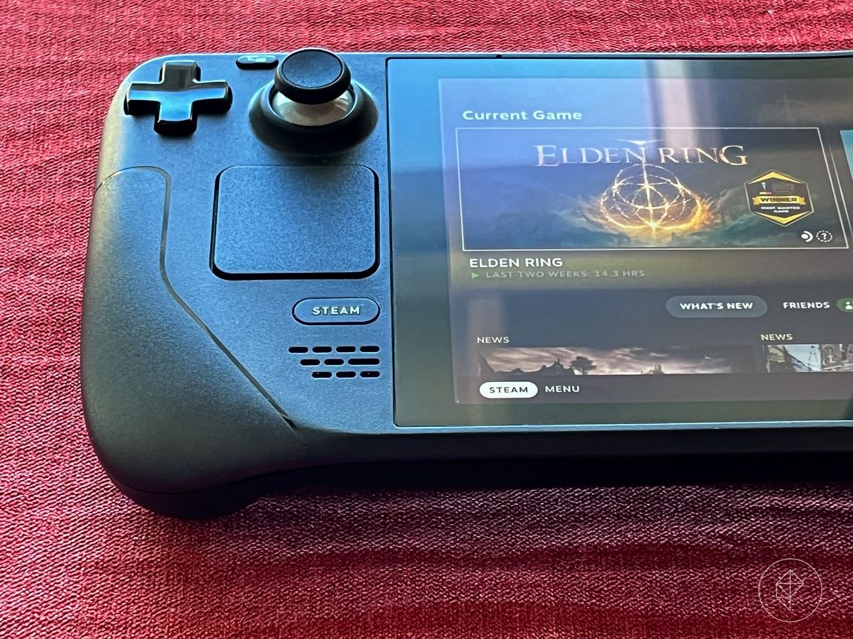 Close up photo of Steam Deck hand-held gaming device on a red material