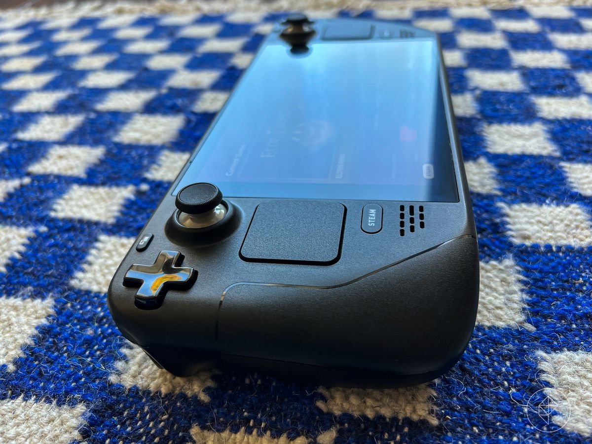 Close up photo of Steam Deck hand-held gaming device on blue check material background