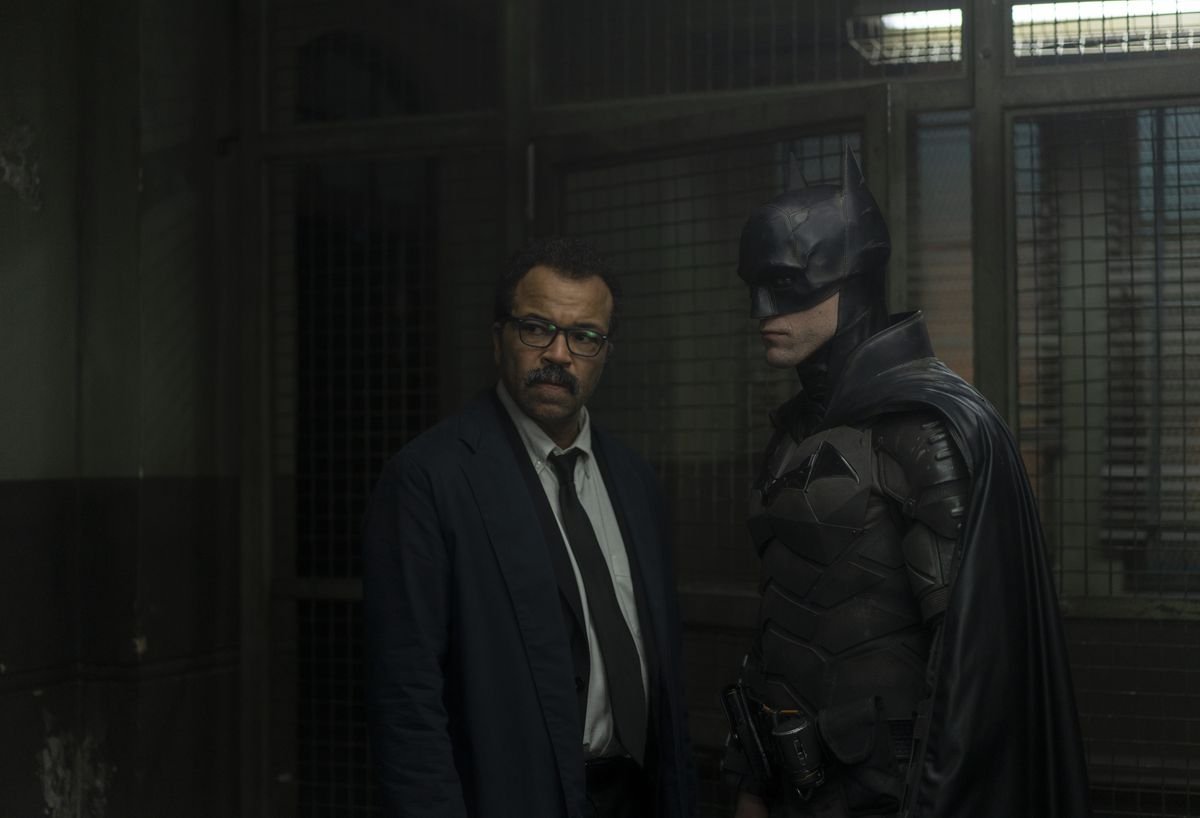 Lt. Gordon and Batman stand in the Gotham Police precinct.