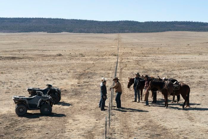 The two ranch families of Outer Range stand at the fence negotiating 