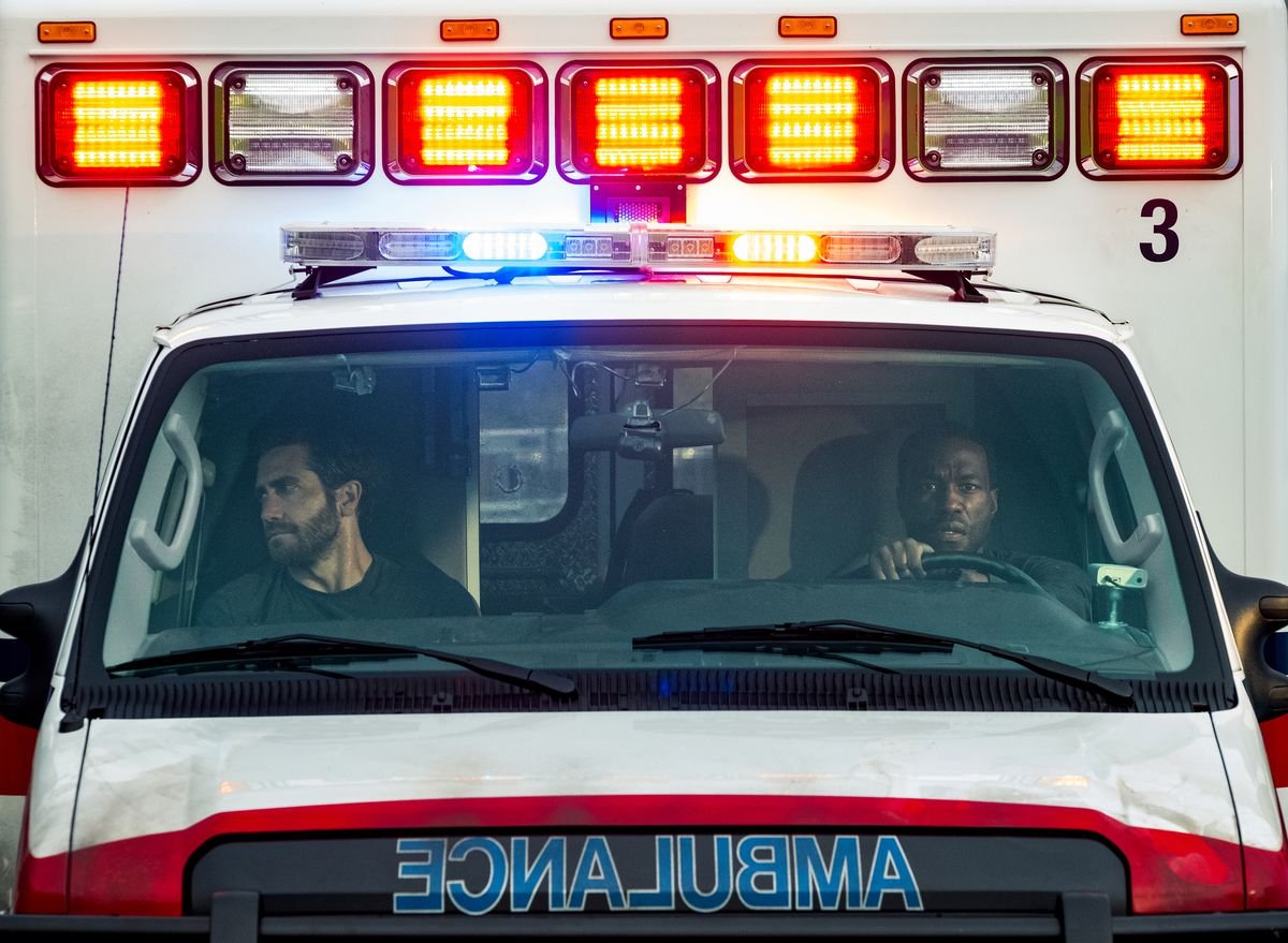 Jake Gyllenhaal and Yahya Abdul-Mateen II sit in the cab of an ambulance in Ambulance