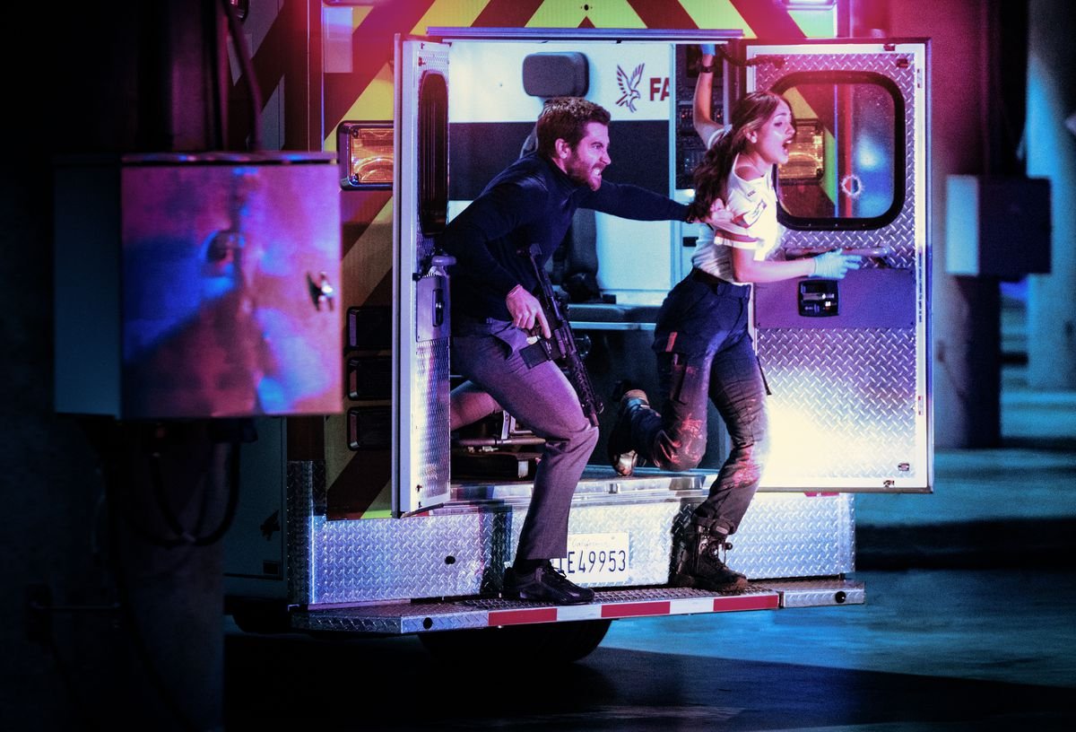 Jake Gyllenhaal and Eiza González hang out of the back door of an ambulance in Ambulance