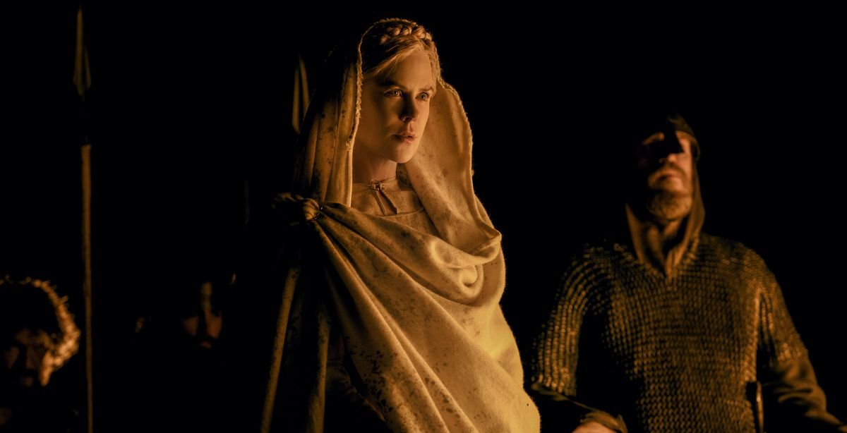 Nicole Kidman wrapped in white cloth by firelight in The Northman