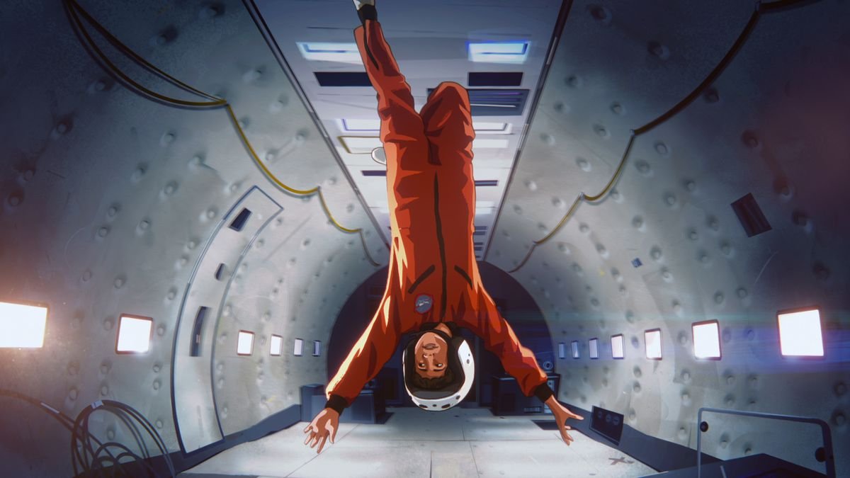 Stanley, in an orange flight suit, floats upside down in zero gravity in Apollo 10 1/2