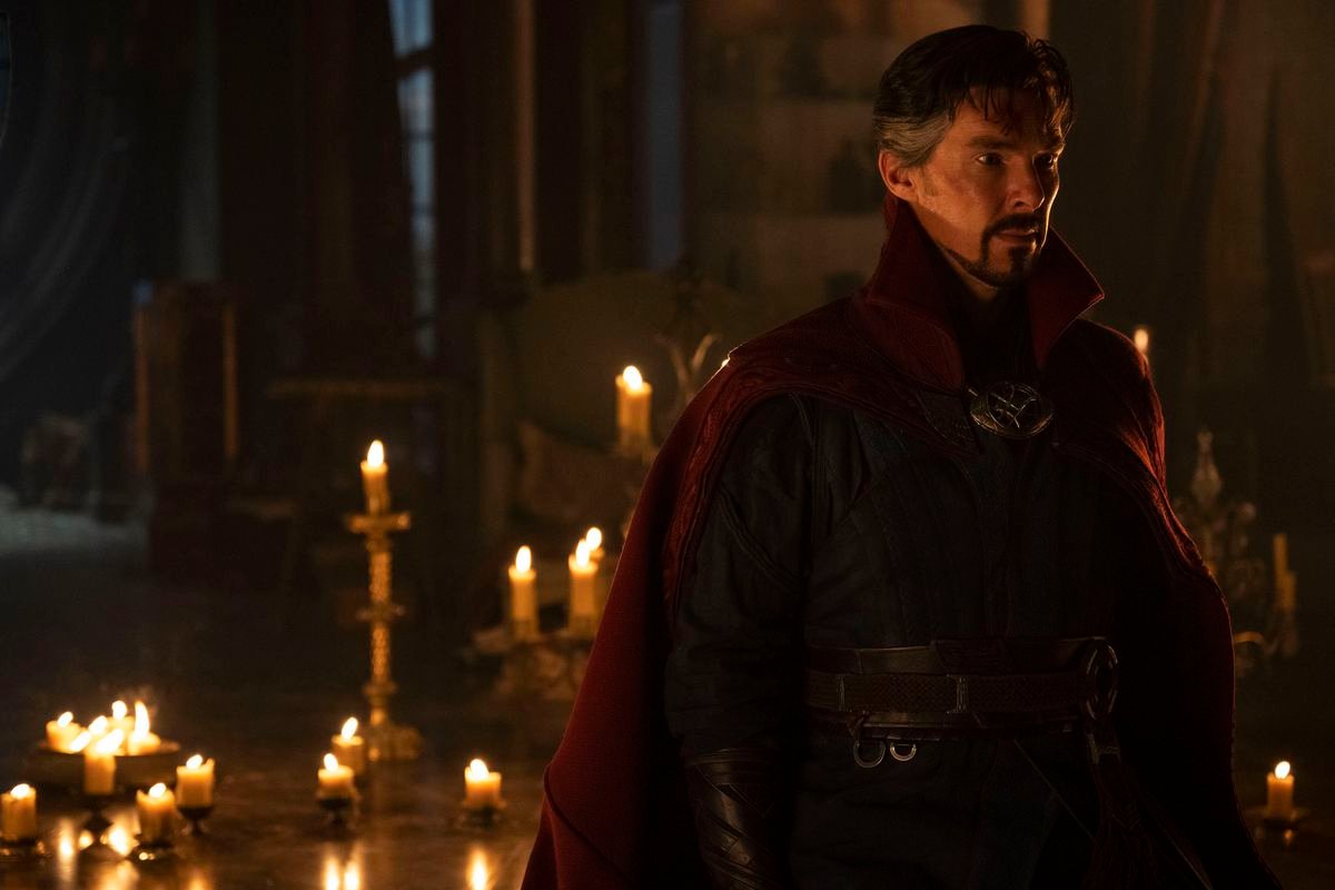 Benedict Cumberbatch as Doctor Strange standing in front of a bunch of candles and looking super duper extra broody in Doctor Strange in the Multiverse of Madness.