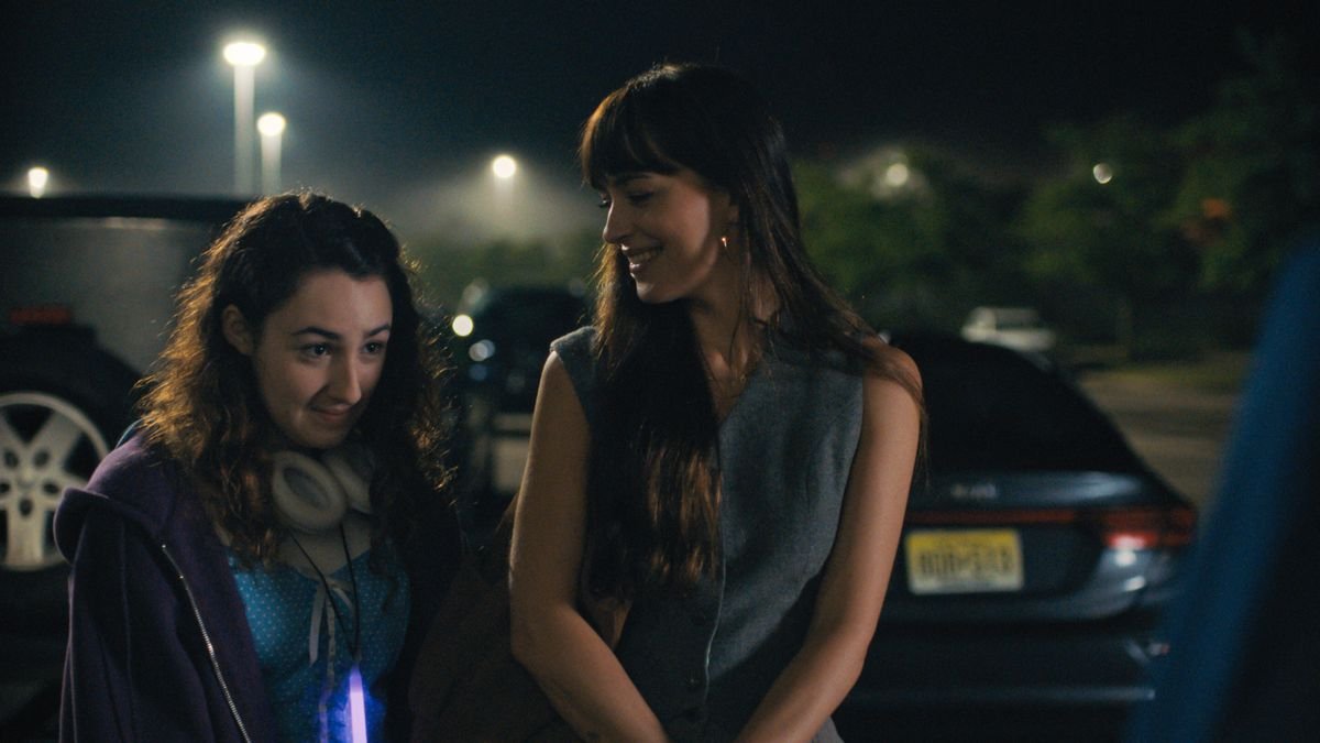 Domino (Dakota Johnson) and her daughter Lola (Vanessa Burghardt) stand outside together in Cha Cha Real Smooth