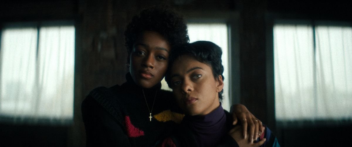 Beauty (Grace Marie Bradley) and Jasmine (Aleyse Shannon) stand together, staring into the camera with their arms draped over each other, in Netflix’s Beauty.