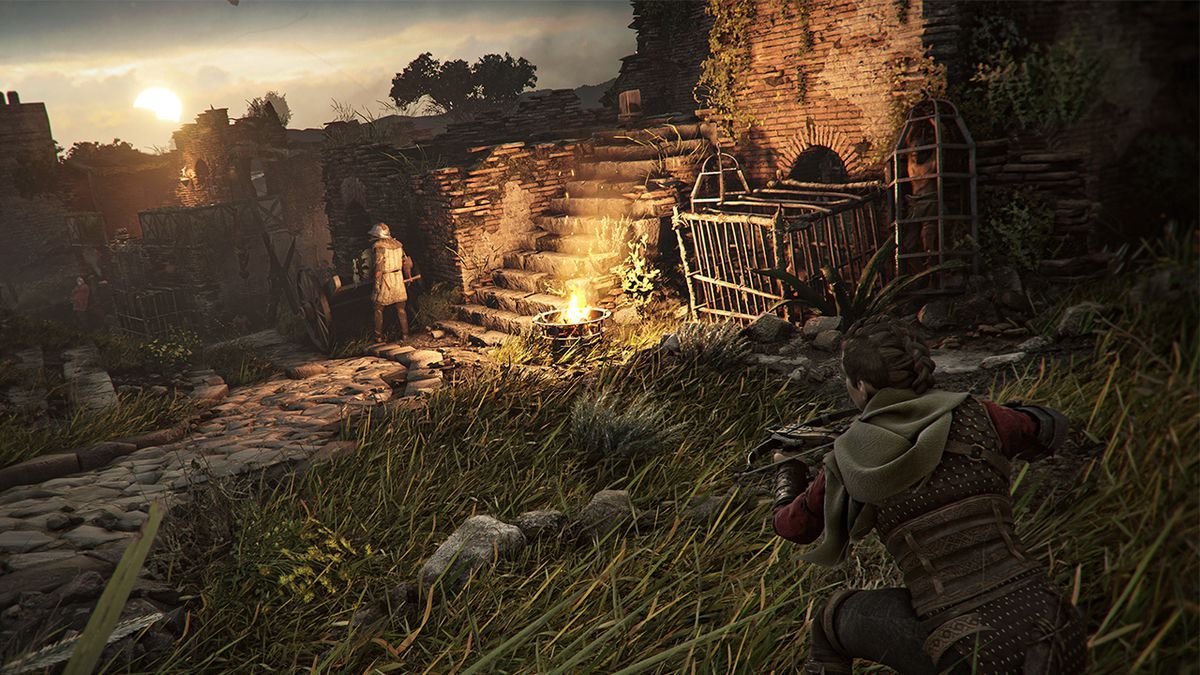 Amicia sneaks through tall grass and aims her crossbow at a nearby enemy during dusk in A Plague Tale: Requiem