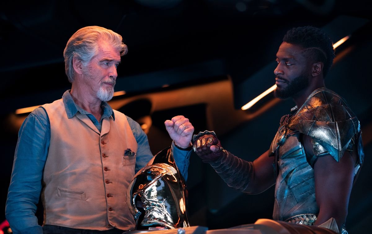 Pierce Brosnan as Doctor Fate and Aldis Hodge as Hawkman give each other a little fist-bump in a scene from Black Adam