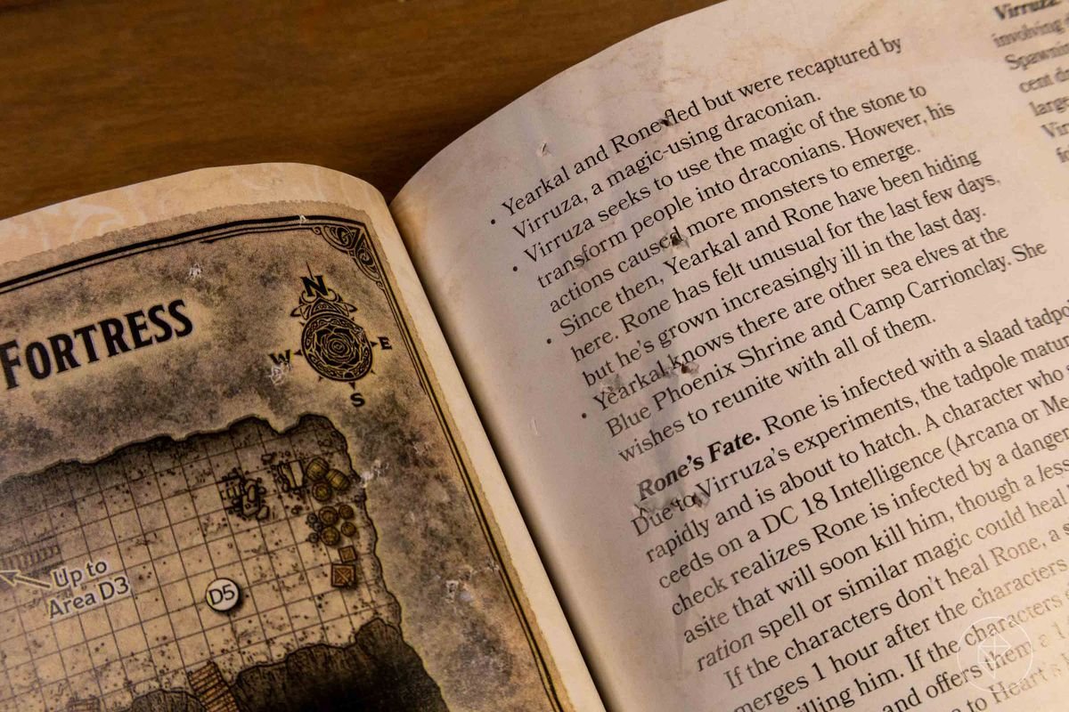 A damaged page from a book, showing piercing holes in the page.